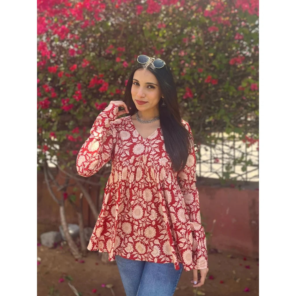 Women wearing a red floral printed cotton Alia top with full sleeves