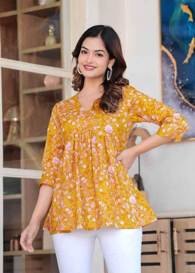 Women's mustard yellow floral printed cotton tunic top with relaxed fit and three-quarter sleeves