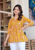 Women's mustard yellow floral printed cotton tunic top with relaxed fit and three-quarter sleeves