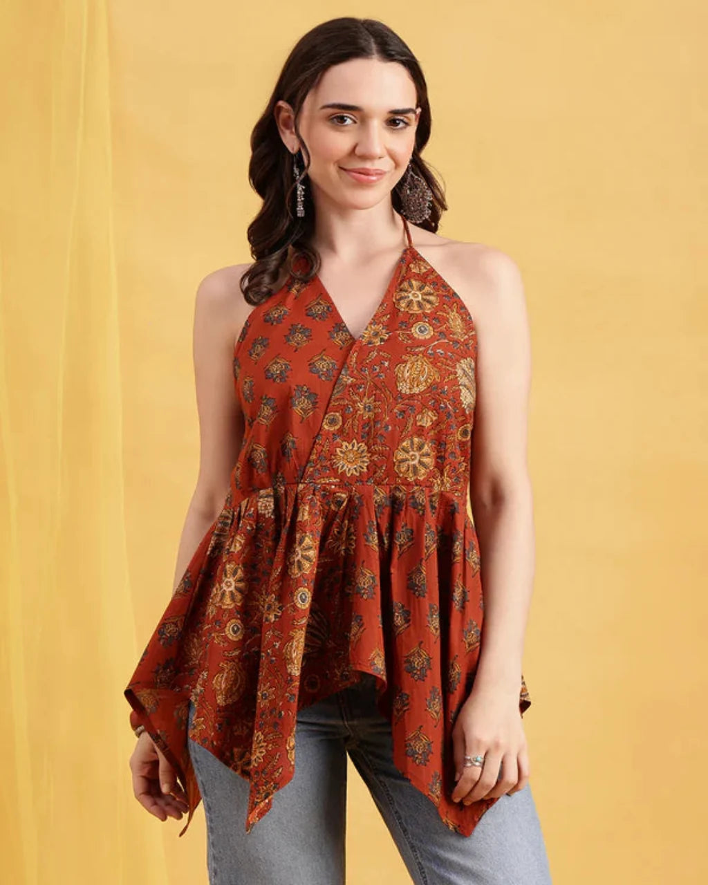 Women wearing rust orange printed cotton halter top with flared peplum silhouette