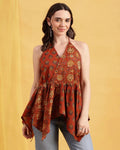 Women wearing rust orange printed cotton halter top with flared peplum silhouette